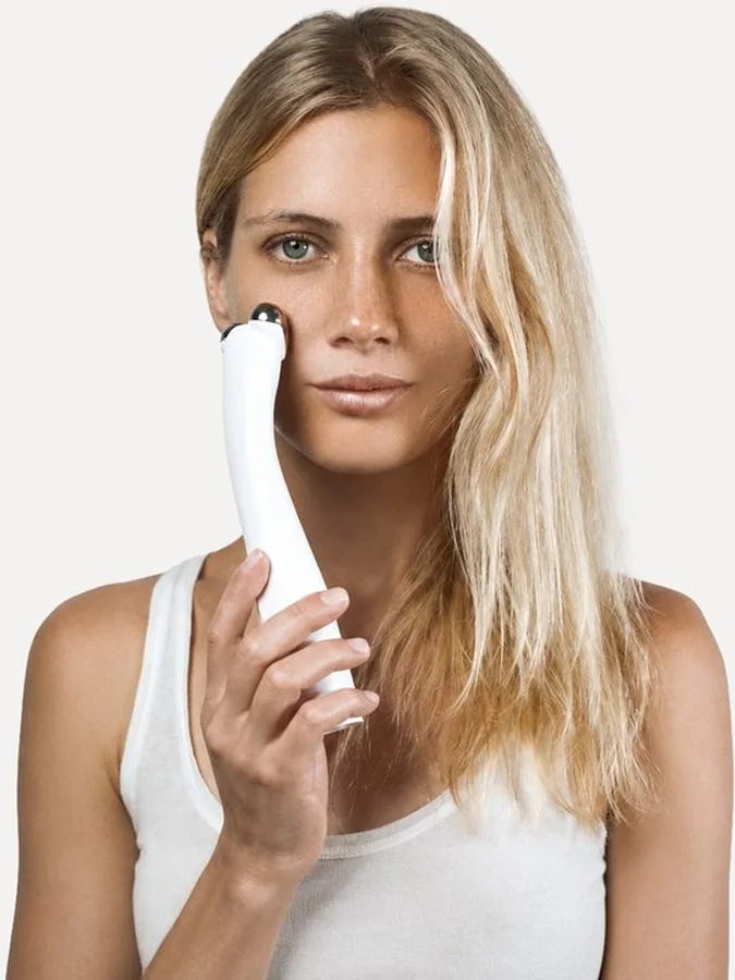 Woman holding PureLift Pro Edition on her cheekbone